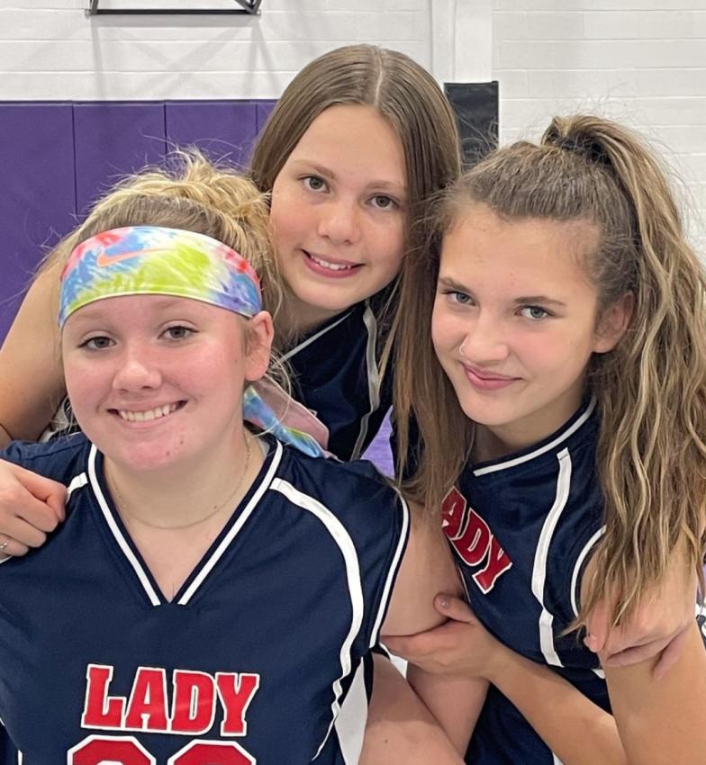 Three WCS volleyball players smile for the camera