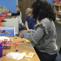 student exploring the writing table